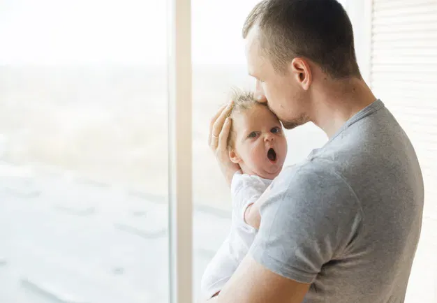 Is It Normal For Your Babies To Yawn Excessively? 1 Dad Kissing Baby With Opened Mouth Forehead 23 2148178992