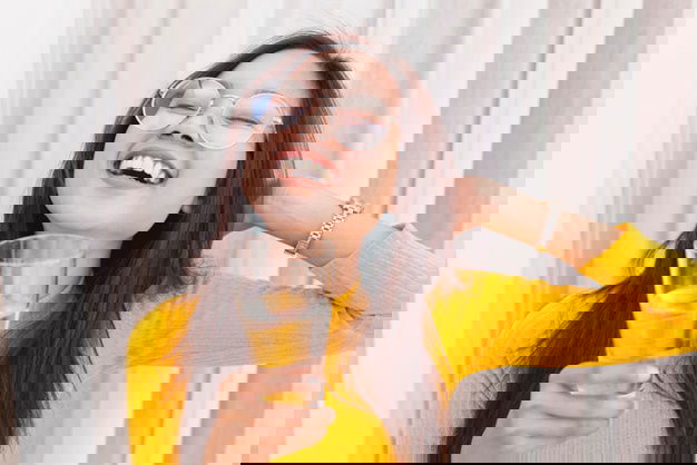 Skincare Tips For Oily Skin- The Ultimate Guide To Understand &Amp; Treat Acne! 23 Girl With Glasses Laughing While Holding Water Glass 23 2147608457