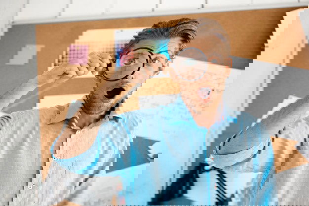 Young Handsome Confident Surprised Businessman Standing Cork Board Through Magnifier White Modern Office Interior 176420 6556