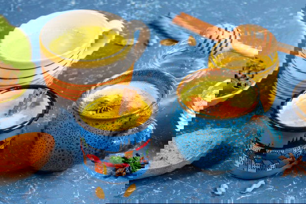 Skin Pigmentation- Home Remedies For Pigmentation 10 Different Cups With Golden Turmeric Milk Ingredients Its Cooking Blue Backdrop Close Up Selective Focus 121867 622