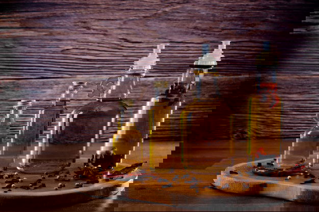 Best Oil For Cooking - Check Out The Healthiest Types! 5 Bottles With Olive Oil With Spices Wooden 149301 281 1