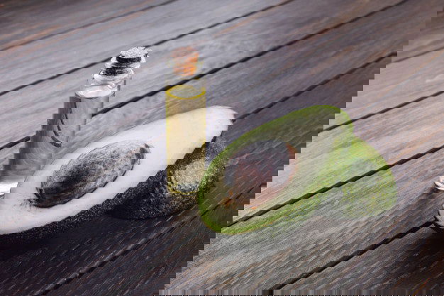 Best Oil For Cooking - Check Out The Healthiest Types! 8 Little Bottle With Oil Avocado Stand Wooden Table 8353 7044