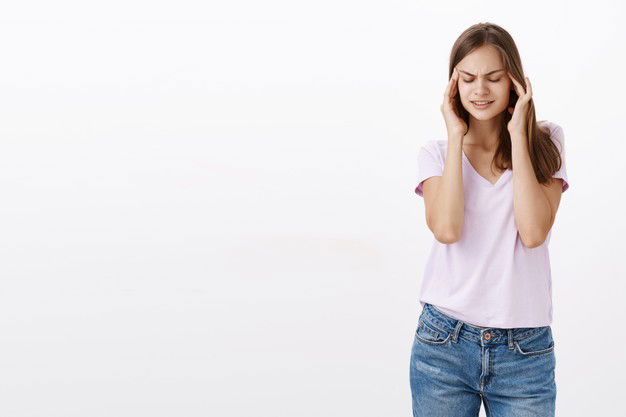 Portrait Intense Cute European Girl With Brown Hair Closing Eyes Holding Hands Temples Head Trying Focus Concentrate Standing Unfocused Grey Wall 176420 23611