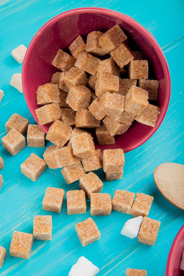 13 Unbeatable Health Benefits Of Palm Jaggery 2 Side View Brown Sugar Cubes Scattered From Pink Bowl Blue Wooden Background 141793 7754 1