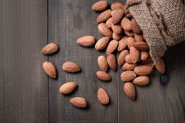 9 Nourishing Almond Oil To Keep Hair Gorgeous 5 Almonds Nuts Peeled Sack Wood Table Almonds Are Very Popular Nuts High Protein Healthy Food 34435 3985