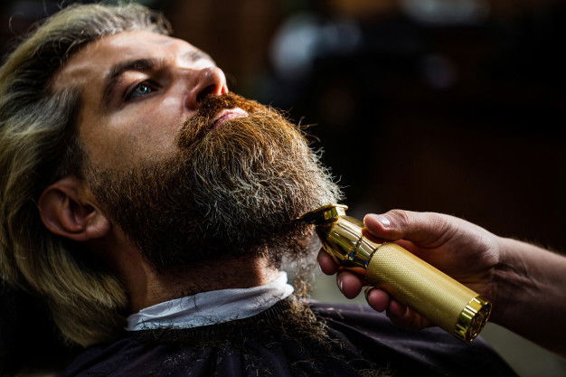 Beard Oil: 5 Benefits And Tips To Maintain Beard 6 Barber Works With Beard Clipper Hipster Client Getting Haircut Hands Hairdresser With Beard Clipper Closeup 293990 50