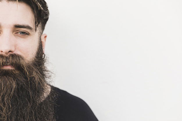 Beard Oil: 5 Benefits And Tips To Maintain Beard 4 Close Up Bearded Young Man Looking Camera Against White Backdrop 23 2148176500