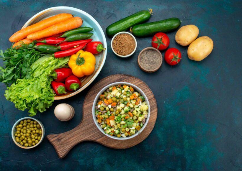 Top View Sliced Vegetable Salad Peppered With Chicken Slices Inside Plate With Fresh Vegetables Dark Blue Desk 2 Scaled 1
