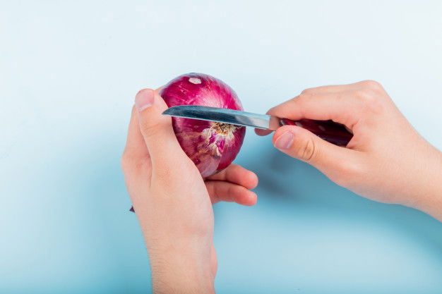 Side View Male Hands Peeling Red Onion With Knife Blue Background 141793 9493