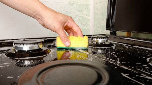 How To Clean Gas Stove Guide 8 Surface Cleaning Woman Washing Gas Stove With Yellow Washcloth Detergent 118478 897