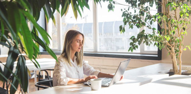 Coronavirus: How To Be Happier While Working From Home 2 Beautiful Caucasian Woman Working Laptop Remotely Bright Space With Green Plants 79087 2430