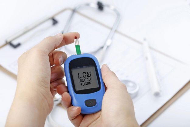 Hand Holding Blood Glucose Meter Measuring Blood Sugar Background Is Stethoscope Chart File 1387 943