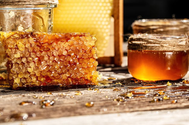 Things That You Should Be Replacing With Honey Right Now 3 Sweet Honey Comb Glass Jar With Honey Wooden Background 114941 304