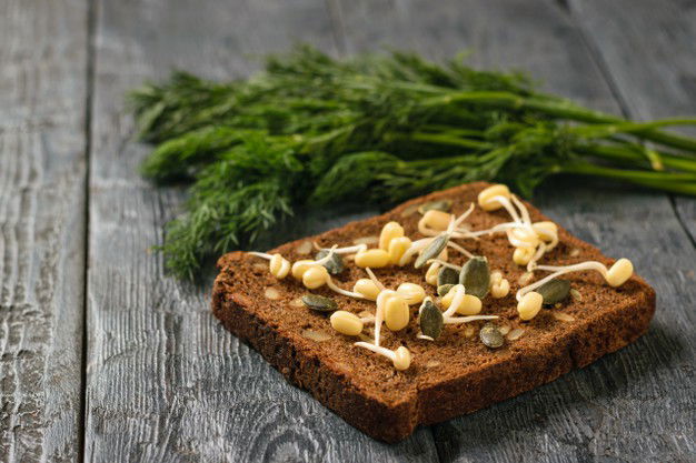 Piece Bread With Sprouted Beans Pumpkin Seeds With Bunch Dill Black Wooden Table 94064 2894