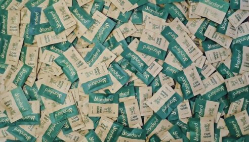 Cane Sugar Sachet Supplier A Pile Of Small Packets Of Cane Sugar Sachet