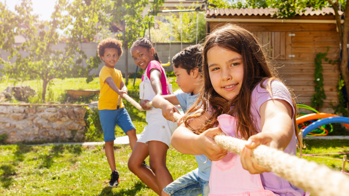 A Group Of Kids Working Together On A Laptop, Demonstrating Teamwork And Collaboration Through Technology.