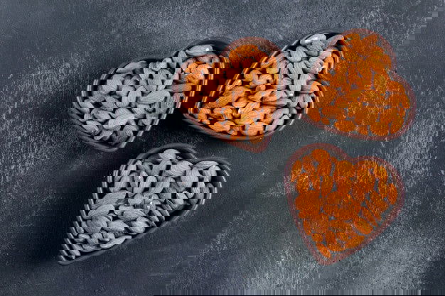 Buy Almonds At Chennai At The Best Price! 2 Almond Heart Shaped Bowls Black Stone Table Flat Lay 176474 1428