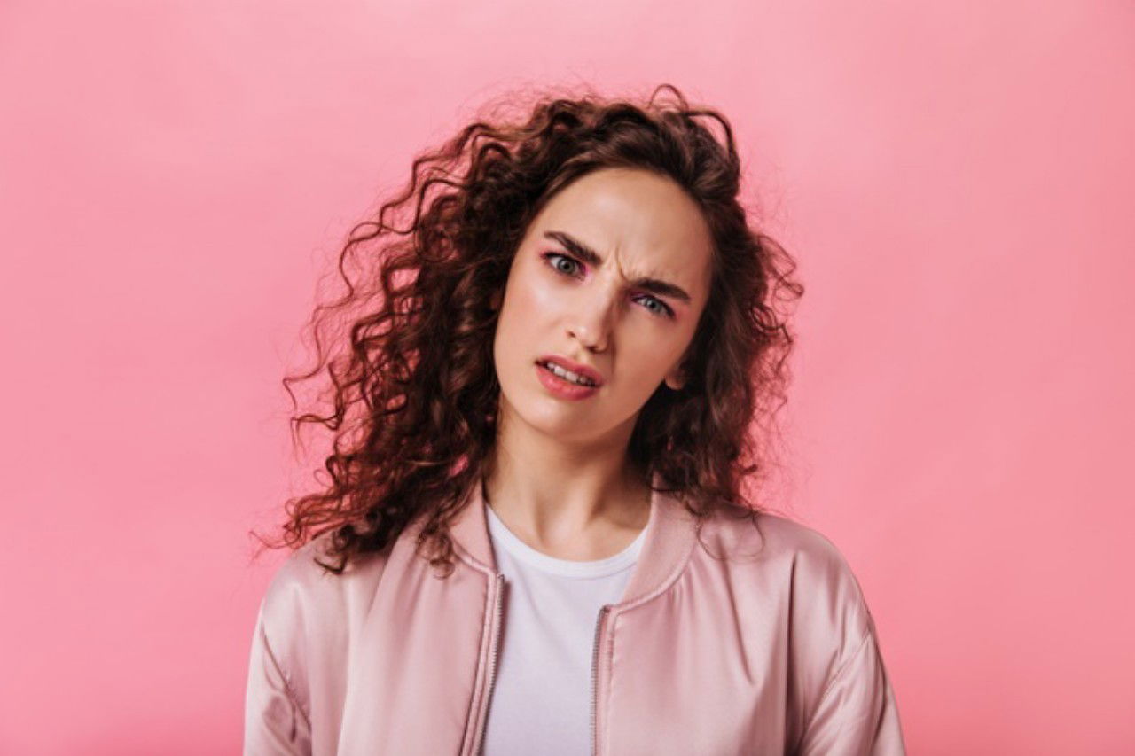 Woman Pink Outfit Looks Into Camera With Misunderstanding 197531