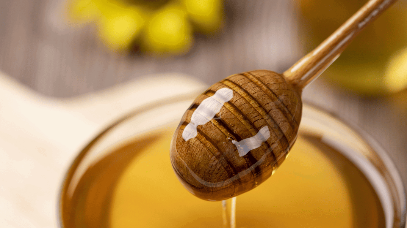 Fresh Jackfruit Pieces Soaked In Golden Honey, Served In A Glass Bowl With A Wooden Honey Dipper Beside I