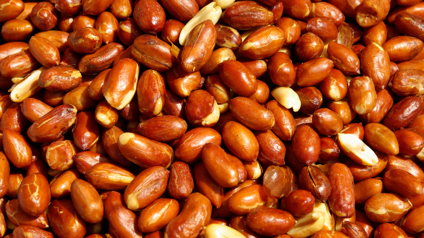 A Selection Of Foods Rich In Vitamin E, Including Nuts, Seeds, And Leafy Greens, Supporting Skin Health And Immune Function