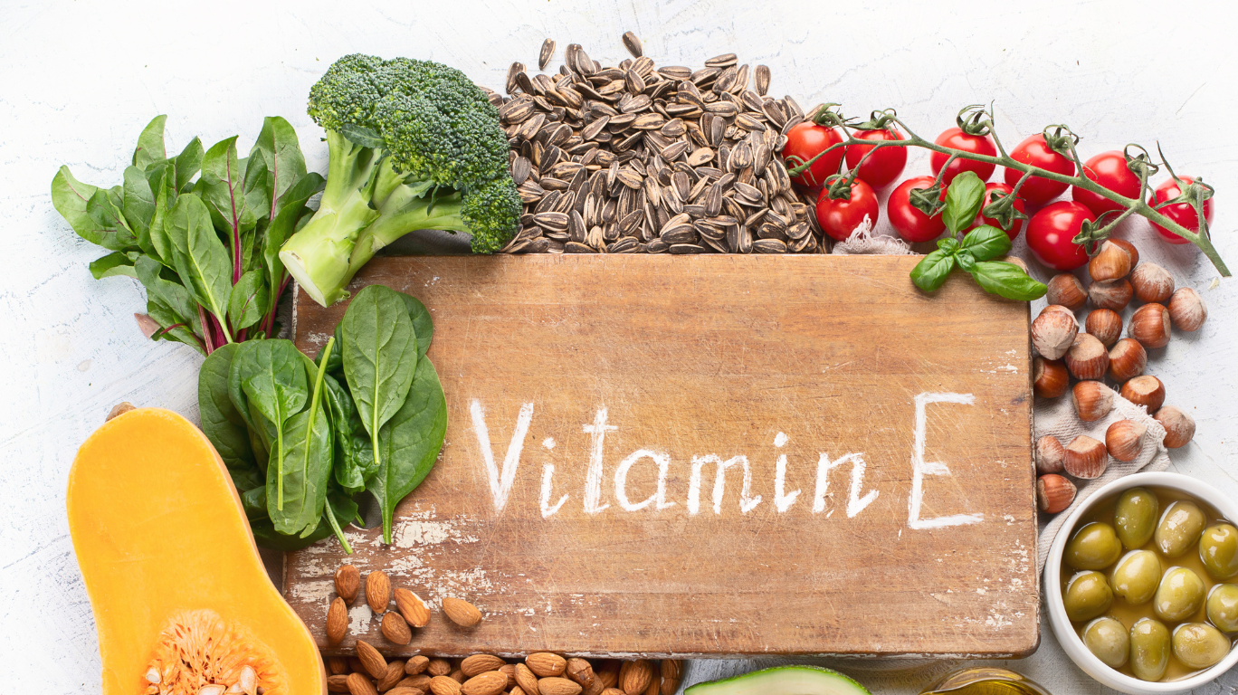 A Selection Of Foods Rich In Vitamin E, Including Nuts, Seeds, And Leafy Greens, Supporting Skin Health And Immune Function