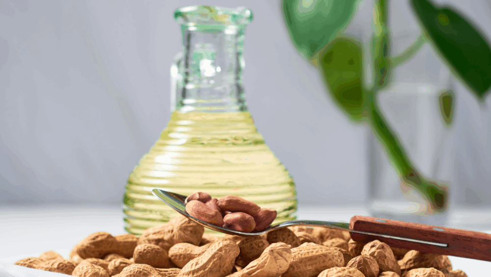 Bottle Of Peanut Oil With Peanuts, Highlighting Health Benefits Like Heart And Skin Care