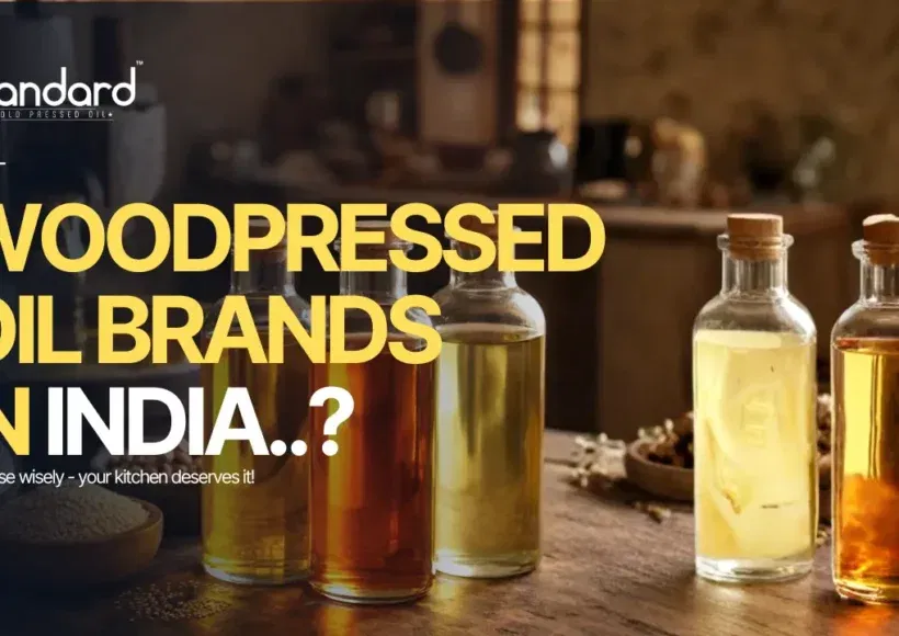 Best Wood Pressed Oil Brands In India Displayed In Glass Bottles With Rustic Kitchen Background, Highlighting Pure Traditional Cold Pressed Oils.