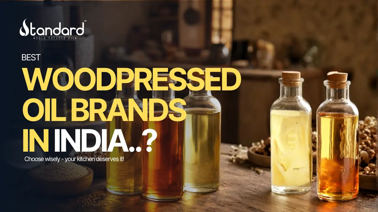 Best - Wood-Pressed Oil Brands In India 1 Best Wood Pressed Oil Brands In India Displayed In Glass Bottles With Rustic Kitchen Background, Highlighting Pure Traditional Cold Pressed Oils.